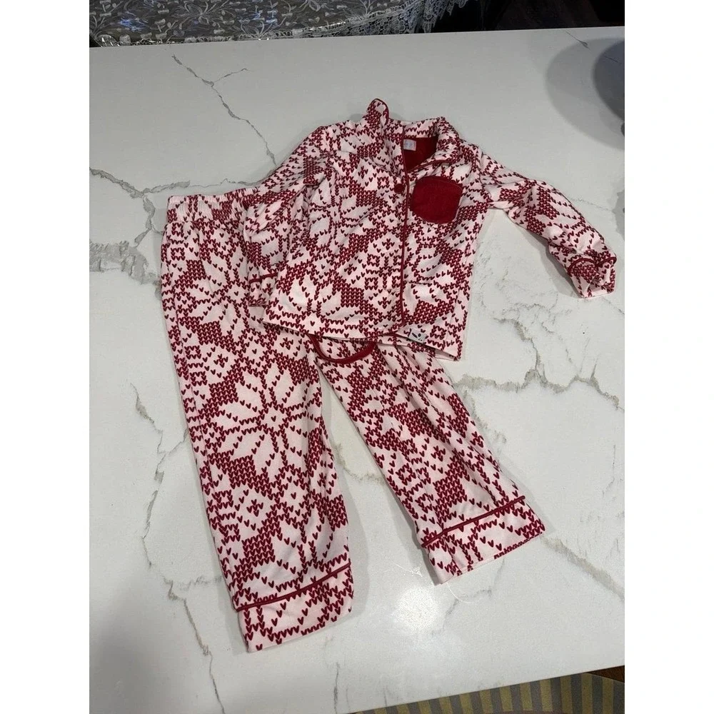 Sweet Honey pajama set features a festive red and white snowflake pattern 2T